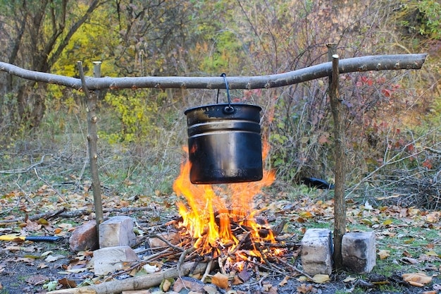 A close-up shot of a well-prepared bonfire setup, including a portable fire pit, buckets filled with water, shovels for sand, a fire extinguisher, and a first aid kit. The shot emphasizes the importance of having the right safety equipment on hand for a safe and responsible beach bonfire.