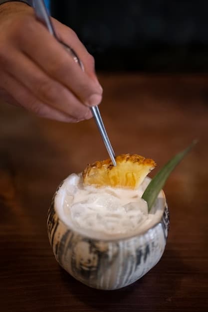 A close-up shot of a bartender expertly crafting a tropical cocktail at a beachside bar, with focus on the mixing process and vibrant ingredients like pineapple, coconut, and various colorful liquors.