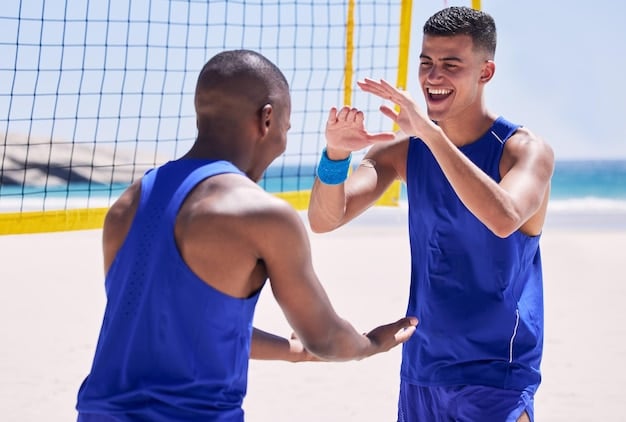 A close-up shot of two beach volleyball players bumping fists in celebration after scoring a point, exemplifying teamwork and good sportsmanship. The background is blurred, focusing on their camaraderie.