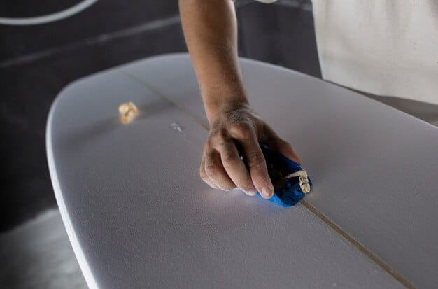 A close-up shot of a surfboard, highlighting the volume markings and a hand measuring the board's thickness. The image should convey precision and attention to detail.