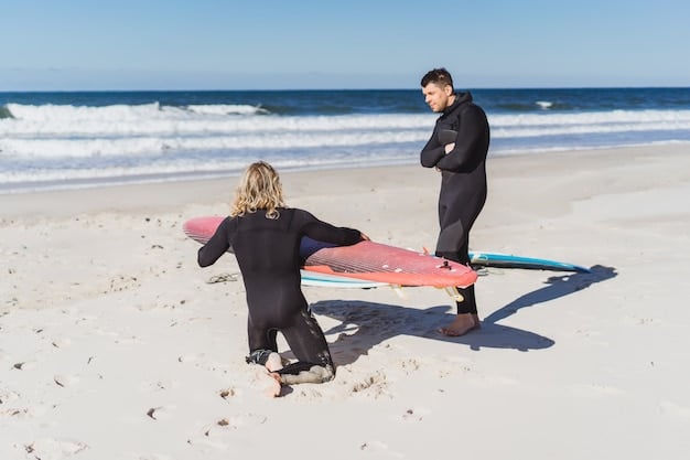 A surfboard shaper explaining the importance of volume to a surfer in a workshop, pointing to different sections of a board. The scene should be well-lit and professional.