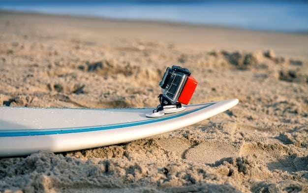 A kitesurfer using a waterproof radio to communicate while on the water. The image focuses on the radio and the kitesurfer's hand operating it.