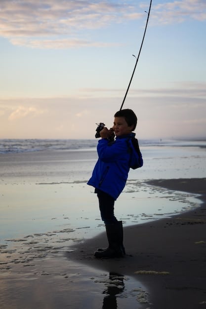 A close-up shot of a beginner angler holding a fishing rod, with hands demonstrating the proper grip and stance for casting into the surf. The focus is on the angler's hands and the rod.