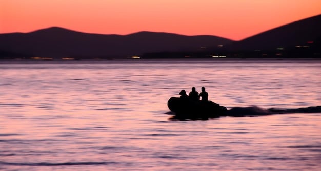 A shot of a calm coastline at sunset. A person is riding a jet ski at a safe distance from the shore.