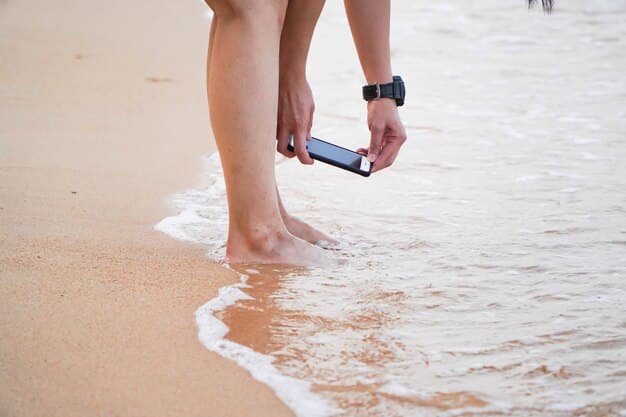 A person rinsing their foot with water from a water bottle at the beach after stepping on a shell.