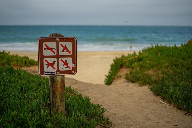 A detailed shot of a regulatory sign posted on a beach, indicating access restrictions and environmental protection rules.