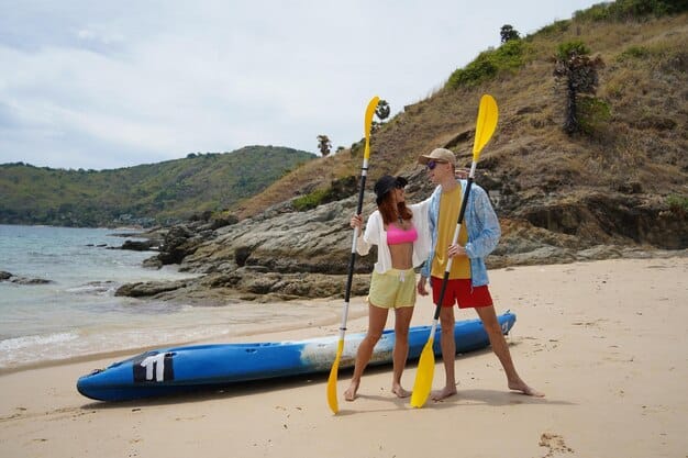 Guests enjoying various water activities on a private beach at a luxury resort, including paddleboarding, kayaking, and snorkeling.
