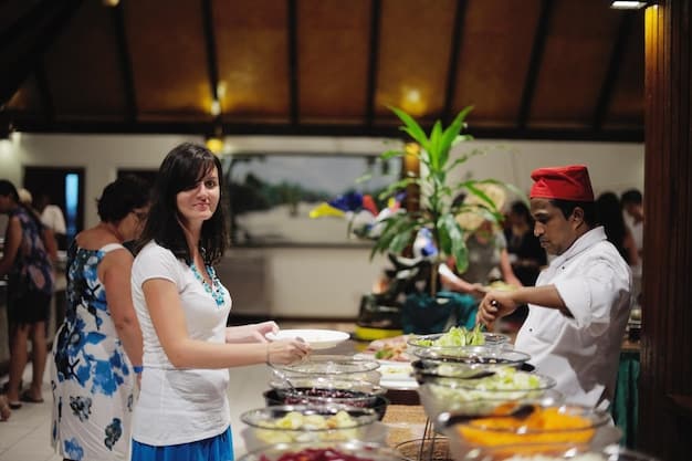 A group of guests participating in an interactive cooking class at a luxury beach resort. The guests are gathered around a cooking station, wearing aprons and following the instructions of a chef. The atmosphere is fun and engaging, with guests laughing and interacting with each other.