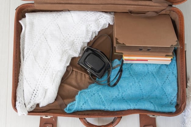 A neatly organized suitcase open on a light surface displaying a variety of carefully folded and rolled women's beach vacation clothing including colorful swimwear pieces, linen shirts, sun dresses, and a beach hat.