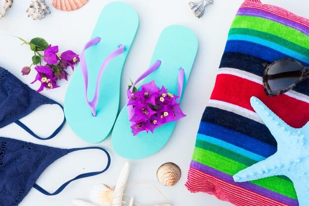 A close up showcases a curated selection of women's beach footwear, neatly arranged on a white surface. The collection includes stylish leather sandals with delicate straps, a pair of elegant espadrille wedges, and some waterproof flip-flops.