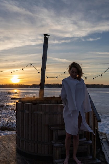 A serene spa scene with a person receiving a massage on a beachfront cabana, featuring ocean views, soft lighting, and aromatic candles, emphasizing relaxation and wellness.