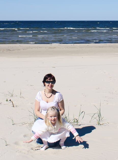 A family enjoying a sunny day on a beach during spring in Outer Banks, North Carolina. The weather is mild, and the beach is relatively empty.