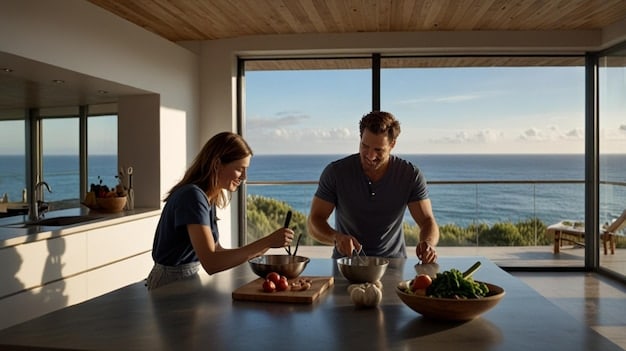 A couple is cooking together in the kitchen of their vacation rental. They are smiling and preparing a simple meal with fresh ingredients. The kitchen is well-equipped and has a view of the ocean.