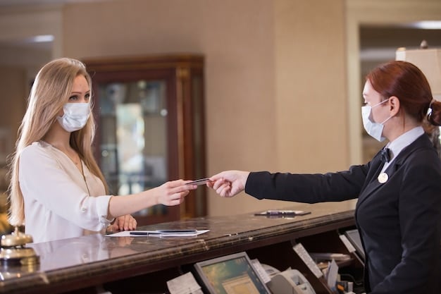 A student showing their student ID at a hotel front desk to receive a discount. The hotel lobby is bright and modern.
