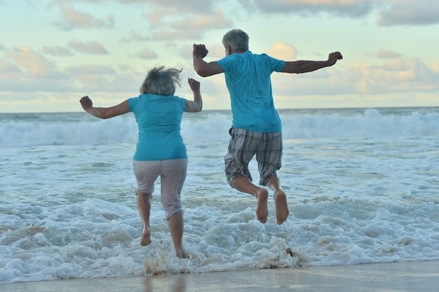 An image of a senior couple laughing and enjoying themselves while participating in a beach activity, like volleyball or frisbee, with other people in the background.
