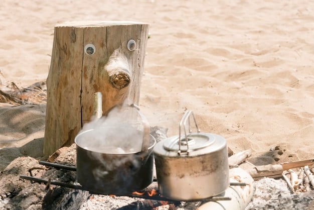A close-up of a camp stove with a wind screen demonstrating effective cooking in a sandy environment, with beach background.
