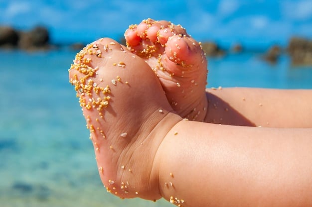 A close-up of bare feet sinking slightly into soft, golden sand, with a blurred ocean background, highlighting the natural resistance.