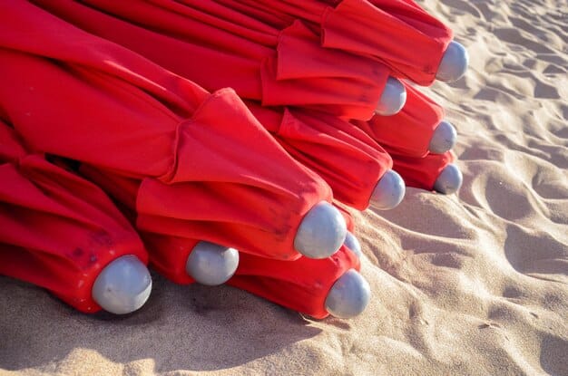 A detailed close-up of a beach umbrella's durable, UV-resistant fabric texture, showing the tight weave and a tag indicating UPF 50+ protection, highlighting material quality.