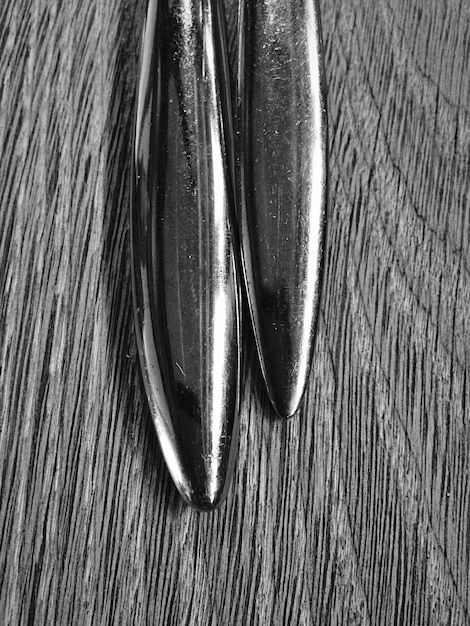 A detailed close-up of a surfboard's fin setup, showcasing twin fins, with a background of ocean waves in soft focus, emphasizing the importance of board mechanics.
