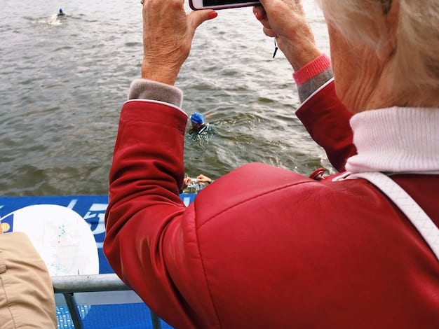 A close-up shot of a jet ski hull, with a person's hand pointing to a small stress crack near the keel. The hull is a vibrant color, and the water surface reflects faintly.