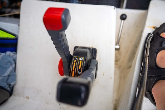 A close-up of a jet ski handlebar with a hand attaching a red coiled safety lanyard to the kill switch receptacle, illustrating the pre-ride check.