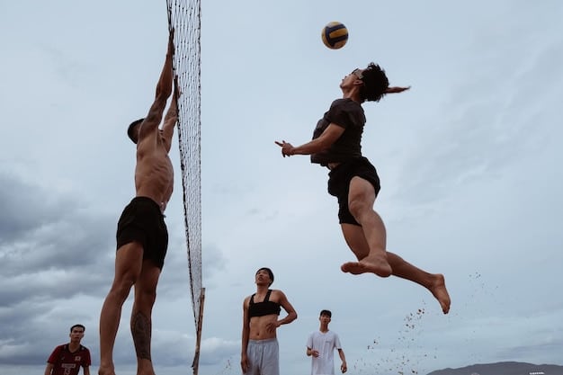 A beach volleyball player in mid-air, executing a powerful spike, with the opposing team setting up a defensive block.