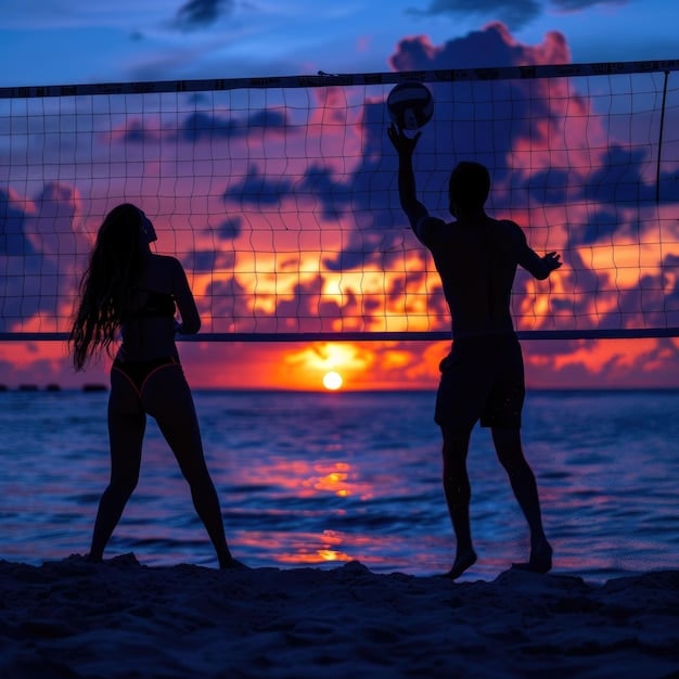 A panoramic view of a beautiful beach volleyball court at sunset, with two players shaking hands over the net, signifying good sportsmanship and competition.