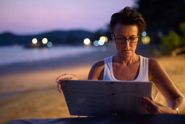 A traveler meticulously looking at a laptop screen with a resort booking page open, highlighting the small print with a finger, emphasizing the act of careful review and research.