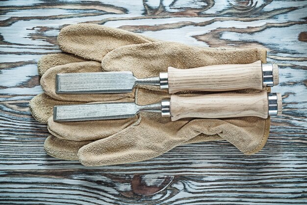 A neatly organized collection of surfboard waxing tools laid out on a wooden table, including two different temperature wax blocks, a wax comb with a sharp edge, and a small bottle of citrus wax remover, all under natural light.