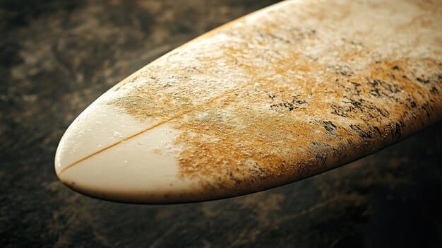 A detailed shot of a wax comb gently raking the surface of a surfboard's wax, creating fresh texture and bumps.